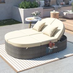 an outdoor daybed with pillows and drinks on it