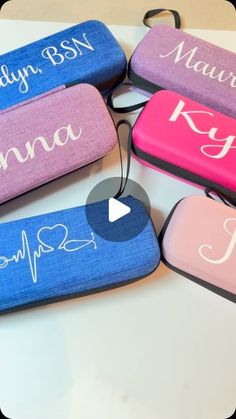 four personalized cases are sitting on a table with the names of their respective people