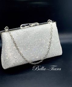 BELLA TIARA INTRODUCES OUR ELEGANT CRYSTAL PURSE COLLECTION A MUST HAVE FOR ANY SPECIAL OCCASIONelegant all around crystal clutch purse perfect for all your essentials, soft and elegant removable chain satin lined. crystal all around, soft satin lined perfect for any size cell phonemeasures approx 7" long x 4" high. -------------------------------------- *Note processing time is not shipping time, our regular Free shipping takes approx. 5-6 days to receive after shipped. With rush processing you Prom Handbags Clutch Purse, Silver Clutch Purse Prom, Formal Crystal Clutch With Rhinestones, Crystal Evening Bag With Bling For Formal Occasions, Silver Crystal Clutch With Bling, Formal Crystal Evening Bag With Bling, Crystal Clutch With Bling As Gift, Crystal Clutch With Bling For Gifts, Bling Crystal Clutch As Gift