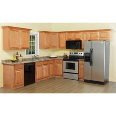 a kitchen with wooden cabinets and stainless steel appliances