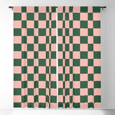 a pink and green checkered curtain hanging on a wall