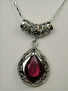 Simulated Red Ruby PendantBig Teardrop Design#P28This is a stunning Victorian inspired pendant necklace. This beautiful necklace is handcrafted from sterling silver. The flawless 6 carat man-made red ruby is a pear cut gemstone. Measurements are 16mm in length and 12mm in width. The 1.5mm sterling silver chain is 18" long (Chain may be different than pictured). The entire pendant is 1-11/16" long by 13/16" wide. The pendant & necklace are marked 925 for sterling silver. Notice the beautiful craf Red Pendant Necklace With Intricate Design, Victorian Ruby Necklace, Victorian Red Sterling Silver Jewelry, Red Ruby Victorian Necklace, Gothic Ruby Necklace, Ruby Necklace Pendant, Ruby Pendant, Filigree Design, Simple Beauty