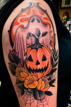 a woman with a tattoo on her arm has a pumpkin and bird in the center