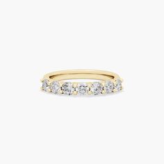 a yellow gold ring with five diamonds