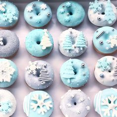 a box filled with blue and white frosted doughnuts covered in icing