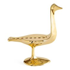 a golden duck shaped object on a white background