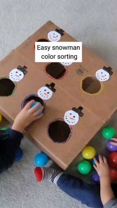 two children playing with an easy snowman color sorting game