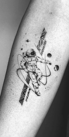 a black and white photo of an astronaut tattoo