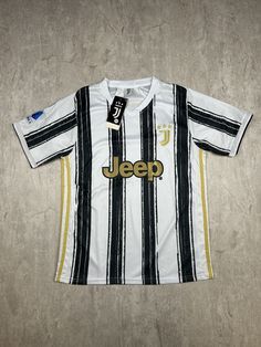 This Juventus Soccer Jersey is brand new with tags (NWT) and features the classic white design with black stripes, representing the home shirt for the 2020-2021 football season. The front displays the Jeep sponsor logo prominently, adding to its authentic look. This jersey is designed for men in size M, perfect for any Juventus fan looking to support their team in style. Please refer to the provided pictures for a detailed view of the condition and measurements of this item. We strive to present our pieces as accurately as possible, ensuring you have a clear understanding of their fit and wear. We put in our best efforts to clean and remove any stains, marks, etc. from our vintage pieces, but due to the nature of these items, some imperfections may remain. If you have any questions or requ Leopard Logo, Juventus Soccer, Rochester Ny, Football Season, Football Shirt, Juventus, White Design, Soccer Jersey, Football Shirts