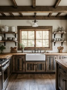 a kitchen with wooden floors and open shelves on the wall, along with a white farmhouse sink