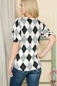 This top boasts a playful Argyle print and comfy, loose fit. The round neck and soft jersey knit make it easy to wear all day, while the pleated puff sleeves add a fun touch. Perfect for a casual day out or weekend adventures. Poly SpanMade In: USA Model is 5'8 wearing size Small Jumper Denim, Holiday Graphic Tees, Argyle Print, Weekend Adventures, Patriotic Tees, Usa Outfit, Sweaters And Leggings, Puff Sleeve Top, Elbow Length Sleeve