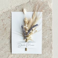 dried flowers are placed on a piece of paper