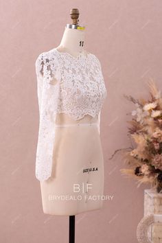 This designer bridal bolero is made out of beautiful flower lace and illusion tulle underneath, featuring exquisite scalloped lace trim adored along the boat neckline, long sleeve cuffs, edge of front bodice and the open back. It will match perfectly with bridal pantsuits and skirts in any silhouette. shown color light ivory bra support no boning no closure back button lining no lining Scalloped Lace Top For Wedding, Long Sleeve White Lace Top For Wedding, Lace Top With Long Sleeves For Wedding, White Long Sleeve Lace Top For Wedding, Delicate Lace Long Sleeve Top For Wedding, Long Sleeve Lace Top For Wedding, Delicate Lace Long Sleeve Top, Long Sleeve Lace Crop Top, Bridal Pantsuit