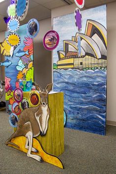 an office cubicle decorated with paper cutouts and artwork depicting kangaroos in front of the sydney opera