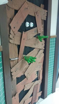 a door made out of wooden planks and fake hands