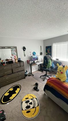 a bedroom with a bed, dresser and rugs on the floor in front of it