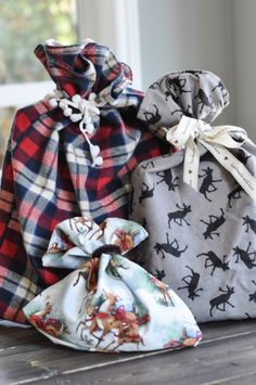 three bags with different designs on them sitting on a table