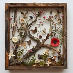 a wooden frame with flowers and butterflies in it