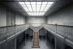 an empty building with stairs and railings