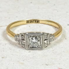 an antique diamond ring with three diamonds on it