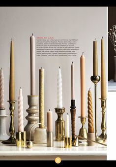 there are many different types of candles on the table and in front of each other