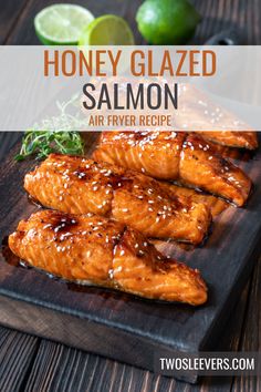 honey glazed salmon on a wooden cutting board with limes and salt in the background