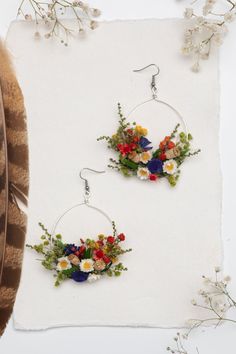 Flower circle dangle earrings in folk style. Can be used for weddings, other events or just everyday use. The earrings are made of preserved flowers, leaves and grass, wire, and other trinkets used for arranging :) Size: width 6cm (2.5 inches), 8cm long. They weight only 8-10g or 3 cm (1.2 inches) - weight 5-8g Please choose the material: 1. GOLD IMITATION HOOK (golden imitation wire/circle + golden imitation hook) 2. SURGICAL STEEL HOOK (silver imitation wire + surgical steel hook) 3. SILVER HO Bohemian Drop Earrings With Pressed Flowers, Bohemian Dangle Earrings With Birth Flower, Botanical Flower Wedding Jewelry, Bohemian Dangle Earrings With Pressed Flowers, Silver Earrings With Pressed Flowers For Wedding, Silver Wedding Earrings With Pressed Flowers, Wedding Silver Earrings With Pressed Flowers, Bohemian Flower Earrings With Birth Flower Details, Bohemian Flower Earrings With Birth Flower