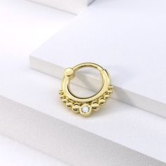 "Make a statement with our exclusive tribal solid gold septum ring with Genuine white diamonds, perfect for adding elegance, luxury and uniqueness to your look Materials: * 14K Solid Gold (Weight: 1.2g) - Available in yellow, rose or white gold. * Genuine White Diamonds (Weight: 0.03ct VS-SI/G-H) Measurements: Wire thickness: 18g - 1mm Inner diameter of the ring: 0.3\" - 8mm Wire thickness \" 16g - 1.2mm Number of diamonds: 1 Diamond size: 2mm * Nickel free and hypoallergenic Fits: septum, tragu Gold Halo Septum Ring For Wedding, Gold Cartilage Earrings With Diamond Accents, Gold Diamond Septum Ring As Gift, Elegant Gold Septum Ring With Halo Detail, Elegant Gold Septum Ring With Halo, Gold Diamond Hoop Piercings, Elegant Halo Hoop Septum Ring, Elegant Gold Halo Septum Ring, Elegant Small Hoop Gold Septum Ring