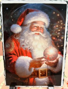 a painting of santa claus holding a christmas ornament