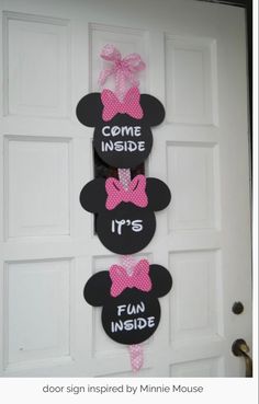 mickey mouse door hangers with pink bows and some words that read come inside it's fun inside