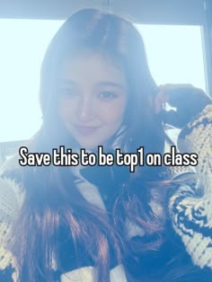 a girl with long brown hair wearing a white and black sweater is holding her hand up to her ear