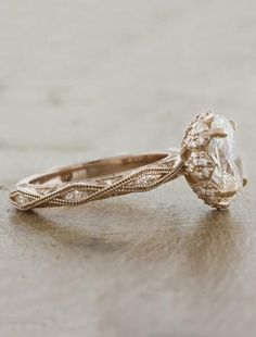 an antique style diamond engagement ring on a table