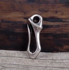 a pair of scissors sitting on top of a piece of cloth next to a wooden wall