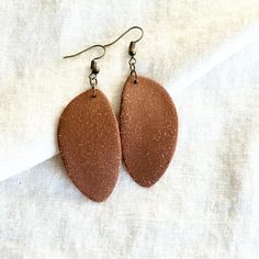 Elevate your accessory game with our exquisite handmade ceramic earrings. These unique clay earrings are perfect for anyone looking to treat yourself, or looking for a great gift. The geometric minimalist design makes these earrings a stunning match for any outfit. Lightweight feel and stylish, these earrings are a must-have addition to your jewelry collection. Small Batch: We make these earrings in batches of roughly 25 at a time, per color, per shape. Handmade: These earrings are made of real fired ceramic, by our hands, every week. Please keep in mind this means each individual earring will have very slight variations in size, shape and color. We think this is part of the charm and character each pair has, and imagine you do as well. Hypoallergenic: The earring hardware that we use is a Earthy Jewelry With Matching Earrings For Everyday, Earthy Handmade Earrings For Everyday Wear, Everyday Polymer Clay Drop Earrings, Nickel-free Clay Jewelry For Everyday Wear, Nickel Free Clay Drop Earrings, Minimalist Polymer Clay Drop Earrings, Nickel-free Clay Drop Earrings, Minimalist Polymer Clay Earrings With Ear Wire, Handmade Minimalist Clay Earrings