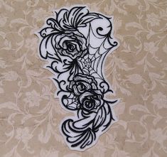 an intricately designed piece of paper with flowers on the side and black outlines