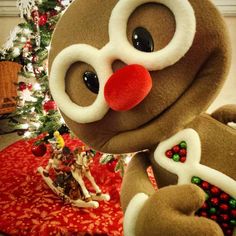 a large stuffed animal next to a christmas tree