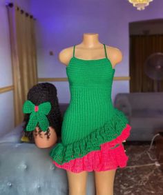 two mannequins dressed in green and pink dresses