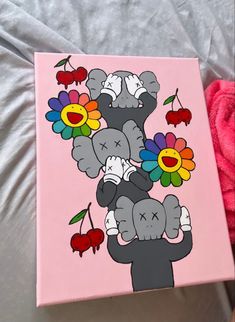 an elephant with flowers painted on it's face is sitting next to a pink blanket