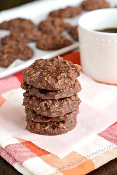 chocolate cookies stacked on top of each other next to a cup of coffee