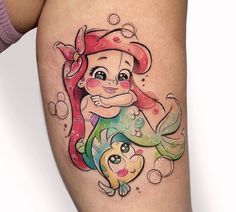 the little mermaid is sitting on top of her mother's stomach, and she has a fish in her hand