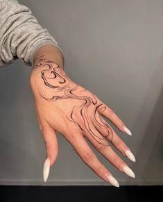 a woman's hand with a tattoo on it