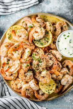 grilled shrimp with lemon and parsley garnish served on a platter