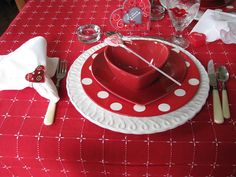 red and white table setting with heart shaped dishes