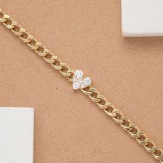 Riley Add a touch of luxury and timeless romance to your wrist with the Diamond Heart 14k Solid Gold Cuban Chain Bracelet. This stunning piece showcases a classic Cuban link chain, meticulously crafted from high-quality 14k solid gold. The centerpiece of the bracelet is a beautiful heart charm, adorned with sparkling diamonds for a touch of sophisticated sparkle. - Handmade- Solid Gold- Natural Diamond - G Color, SI Quality Diamonds- Total Diamond Carat Weight: 0.25 ctw- Dimensions of Heart: 6.5 Gold Cuban Chain, Cuban Chain Bracelet, Solid Gold Bracelet, Sparkling Diamond, Diamond Carat, Cuban Link Chain, Cuban Chain, Cuban Link, Beautiful Heart