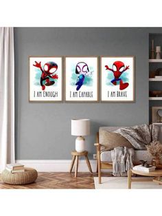 three spiderman posters hanging on the wall in a living room