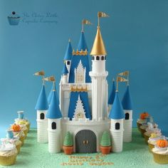 a cake that is shaped like a castle with blue and gold turrets on it's roof