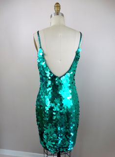 "This is another dazzling vintage party dress! It's fully embellished with bright turquoise green paillette sequins and in excellent condition! Bust - 34/36\" Waist - 28/30\" Hips - 36/38\" Length - 37\" Tag Size - 6 (please refer to measurements) This dress comes from a pet-free and smoke-free home. If you would like more info or have any questions, please don't hesitate to ask!" Glamorous Green Sequin Cocktail Dress, Glamorous Green Sequin Dress For Cocktail, Green Cocktail Sequin Dress With Contrast Sequins, Party Season Green Embellished Sequin Dress, Embellished Green Sequin Dress For Party Season, Green Embellished Sequin Dress For Party Season, Green Sequin Holiday Dress, Green Sequin Dress For Holidays, Glamorous Green Sequin Dress With Contrast Details