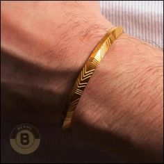 Ditch the dusty textbooks; this bracelet has ancient vibes covered. This sleek stainless-steel bracelet rocks a spunky triangle shape, carved up like a badass Rosetta Stone. There is no need to translate; it spells adventure and mystery.    Metal : Stainless Steel  Color : Golden  Finish : Polished  Total   Weight : 12.11g | Gold 12.95g  Width:  0.24" | 6mm  Diameter : 2.4" | 61mm   Brothers in arms,  BERML  offers you the war-ready stainless steel cuff bracelets every battle requires. Forged for tireless action, steel eliminates weak clasps and instead goes for unbreakable strength.    Run a hand along the smooth polish, or check out our engraved, textured, and mixed metal takes and feel their weight and permanence.     Our stainless steel cuff bracelets have an adjustable wrap constructi Men’s Cuff Bracelet, Mens Golden Bracelet, Elegant Gold-tone Metal Cuff Bracelet, Gold-tone Metal Cuff Bracelet, Tarnish Resistant, Gold Stainless Steel Cuff Bracelet, Tarnish Resistant, Diamante Bracelet, Rosetta Stone, Brothers In Arms, Leather Choker Necklace