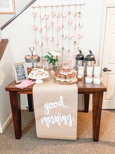 a table topped with lots of food and desserts next to a stair case filled with flowers