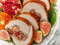 sliced turkey with figs, oranges and cranberries on a platter